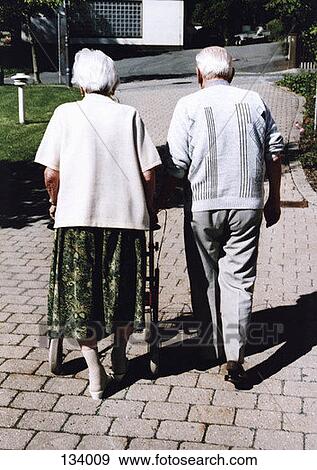 Senior couple walking outdoors View Large Photo Image Stock Photo - Senior couple walking outdoors. Fotosearch