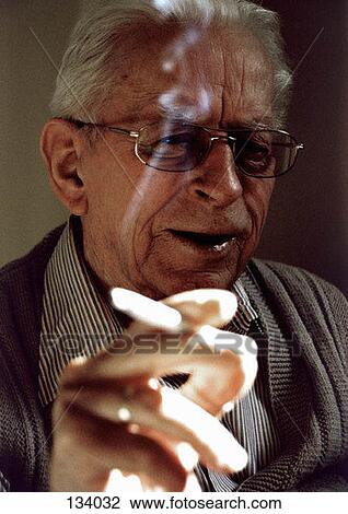 Senior man holding a cigarette View Large Photo Image Stock Image - Senior man holding a cigarette. Fotosearch
