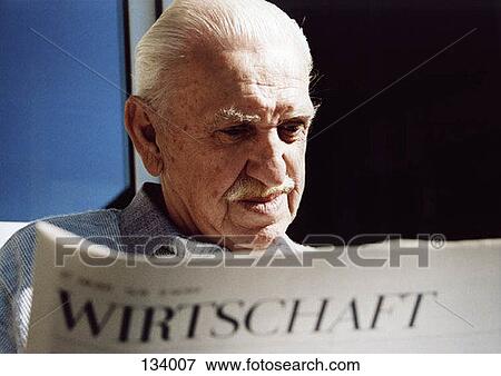 Senior man reading a German newspaper View Large Photo Image Stock Photo - Senior man reading a German newspaper. Fotosearch