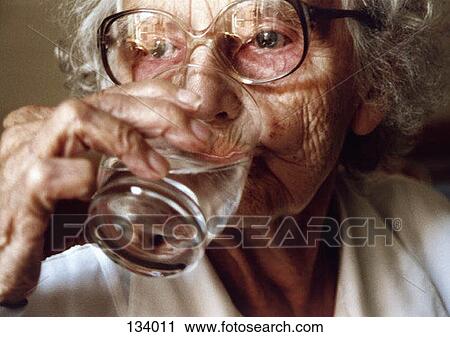 Senior woman drinking a glass of water View Large Photo Image Stock Image - Senior woman drinking a glass of water. Fotosearch