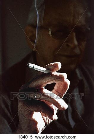 Stock Photography - Senior woman holding a cigarette. Fotosearch