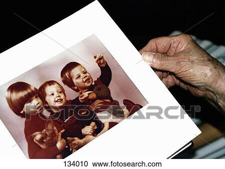 Senior woman holding a photo album View Large Photo Image Stock Image - Senior woman holding a photo album. Fotosearch