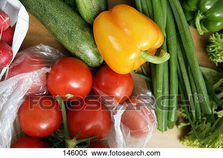 Tomatoes, cucumber and a yellow bell pepper on a wooden table View Large Photo Image Stock Photography - Tomatoes, cucumber and a yellow bell pepper on a wooden table. Fotosearch
