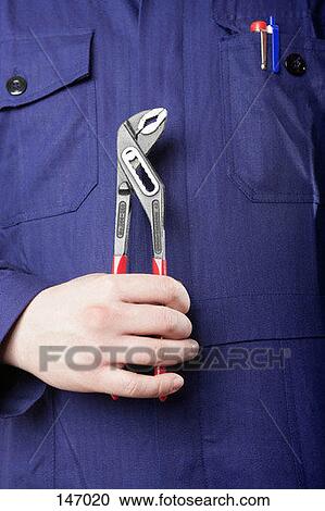 A man holding a wrench View Large Photo Image Stock Image - A man holding a wrench. Fotosearch