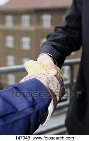 Close up of two men shaking hands View Large Photo Image Stock Photo - Close up of two men shaking hands. Fotosearch