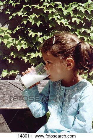Side view of young girl drinking milk View Large Photo Image Stock Image - Side view of young girl drinking milk. Fotosearch