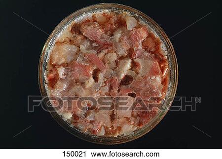 Stock Image - Top view of assorted pieces of meat in a bowl. Fotosearch