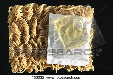 Stock Image - Uncooked Ramen noodles on a black surface. Fotosearch