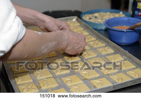 A baker's hands arranging almonds on cookie dough View Large Photo Image Stock Photo - A baker's hands arranging almonds on cookie dough. Fotosearch