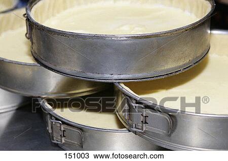 Stock Image - Aluminum pans lined with dough. Fotosearch