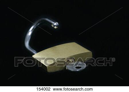 Side view of a small lock lying on a black surface View Large Photo Image Stock Image - Side view of a small lock lying on a black surface. Fotosearch