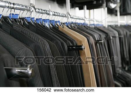 A large number of suits on a clothing store rack View Large Photo Image Stock Image - A large number of suits on a clothing store rack. Fotosearch