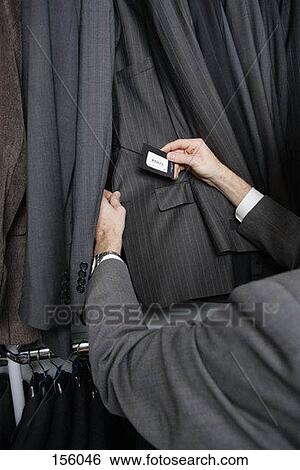 A man shopping for a suit jacket View Large Photo Image Stock Photograph - A man shopping for a suit jacket. Fotosearch