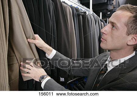 Stock Image - A man shopping for a suit. Fotosearch