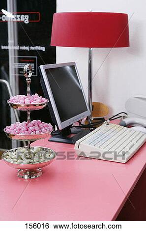 Stock Photograph - A tray of colorful candies near a cash register. Fotosearch