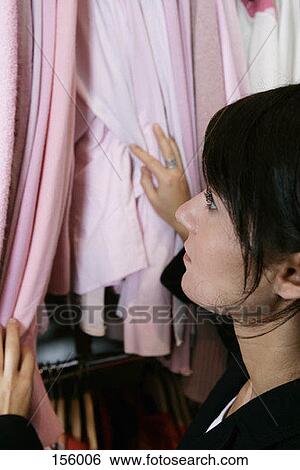 A woman shopping for a shirt View Large Photo Image Stock Photograph - A woman shopping for a shirt. Fotosearch