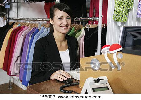 A woman standing at a cash register, smiling View Large Photo Image Stock Image - A woman standing at a cash register, smiling. Fotosearch