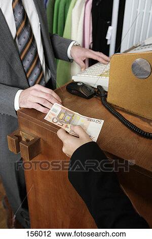 An exchange of money at a store counter View Large Photo Image Stock Image - An exchange of money at a store counter. Fotosearch