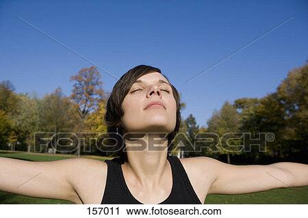 A young woman with outstretched arms View Large Photo Image Stock Image - A young woman with outstretched arms. Fotosearch