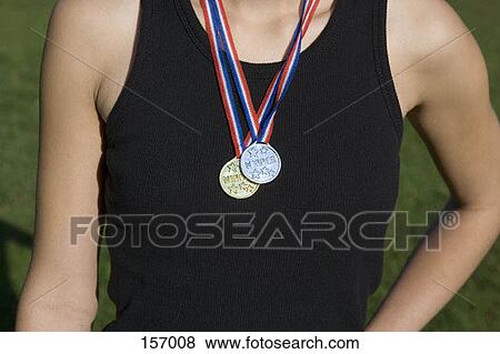 Midsection of a young woman wearing gold and silver medals View Large Photo Image Stock Photo - Midsection of a young woman wearing gold and silver medals. Fotosearch