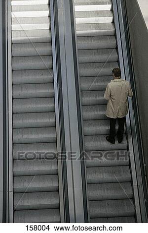 A man going up an escalator View Large Photo Image Picture - A man going up an escalator. Fotosearch