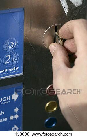 A person putting a coin in a machine View Large Photo Image Stock Photograph - A person putting a coin in a machine. Fotosearch