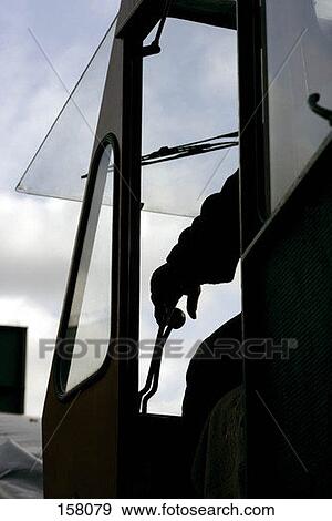 A worker driving a piece of heavy machinery View Large Photo Image Stock Photo - A worker driving a piece of heavy machinery. Fotosearch