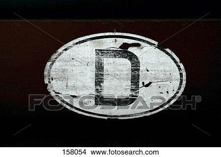 An old sticker with the letter D on a wall View Large Photo Image Picture - An old sticker with the letter D on a wall. Fotosearch
