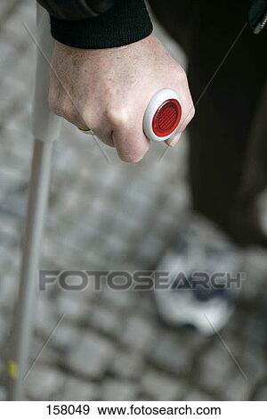 Stock Photo - Close up of a hand walking with a crutch. Fotosearch