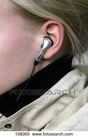 Close up of a headphone in a blond woman's ear View Large Photo Image Stock Photography - Close up of a headphone in a blond woman's ear. Fotosearch