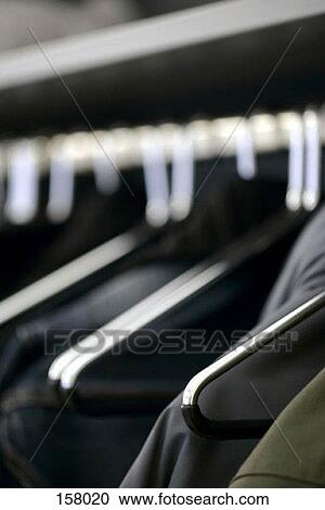 Close up of clothes on hangers View Large Photo Image Stock Image - Close up of clothes on hangers. Fotosearch