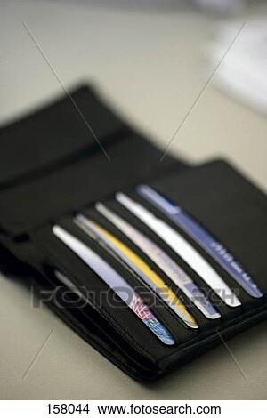 High angle view of a black wallet containing credit cards View Large Photo Image Picture - High angle view of a black wallet containing credit cards. Fotosearch