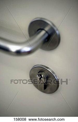 High angle view of a keyhole and a door handle View Large Photo Image Stock Photo - High angle view of a keyhole and a door handle. Fotosearch
