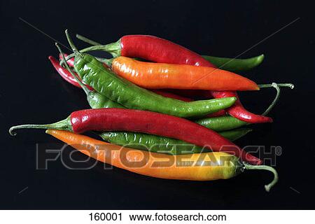 Stock Image - Red, green and yellow chili peppers. Fotosearch