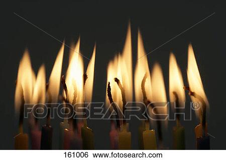Lit birthday candles at night View Large Photo Image Stock Photograph - Lit birthday candles at night. Fotosearch
