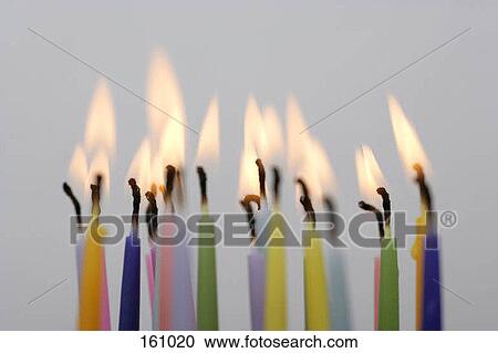 Stock Image - Lit birthday candles. Fotosearch