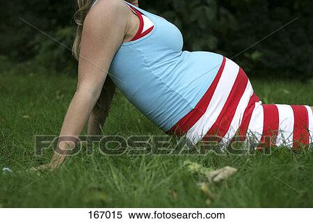 A pregnant woman relaxing in the grass View Large Photo Image Stock Photography - A pregnant woman relaxing in the grass. Fotosearch