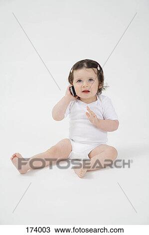 A baby talking on a cell phone View Large Photo Image Stock Image - A baby talking on a cell phone. Fotosearch