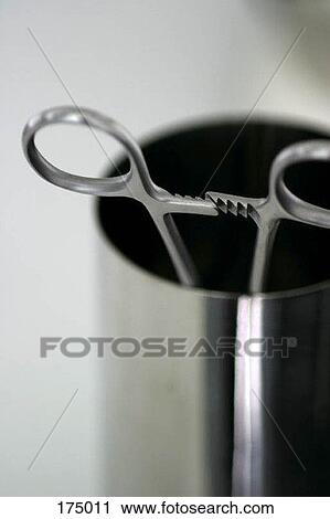 Stock Image - Surgical scissors in a metallic container. Fotosearch