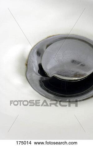 Water pouring into a drain View Large Photo Image Picture - Water pouring into a drain. Fotosearch