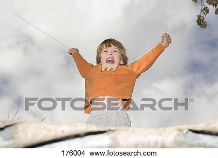 A young boy raising his arms into the air View Large Photo Image Picture - A young boy raising his arms into the air. Fotosearch