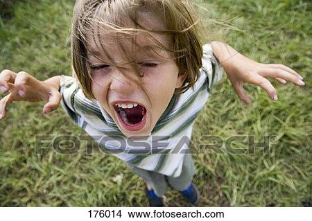 A young boy yelling outdoors View Large Photo Image Picture - A young boy yelling outdoors. Fotosearch