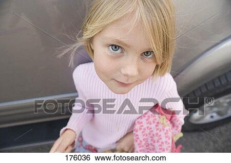 A young girl smiling, high angle view View Large Photo Image Stock Photograph - A young girl smiling, high angle view. Fotosearch