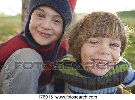 Stock Photography - Two young boys smiling outdoors. Fotosearch