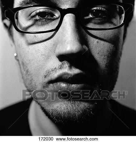 Close up of young man with glasses View Large Photo Image Stock Image - Close up of young man with glasses. Fotosearch