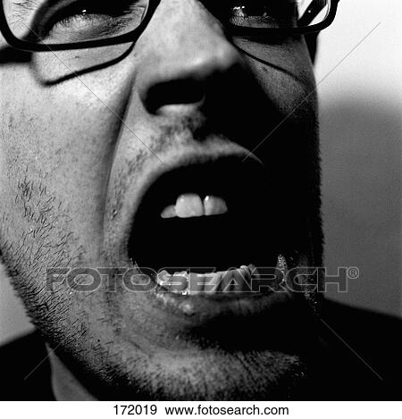 Close-up of young man with mouth open View Large Photo Image Stock Photo - Close-up of young man with mouth open. Fotosearch