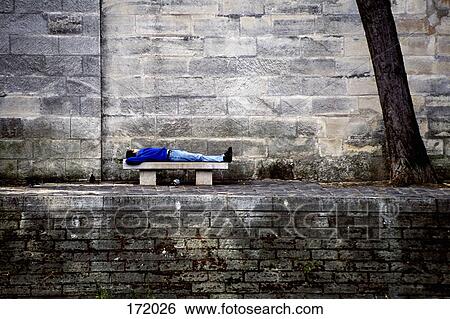 Man lying on a bench by the Seine, Paris, France View Large Photo Image Stock Photograph - Man lying on a bench by the Seine, Paris, France. Fotosearch
