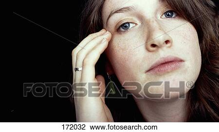 Woman with hand touching face View Large Photo Image Stock Image - Woman with hand touching face. Fotosearch