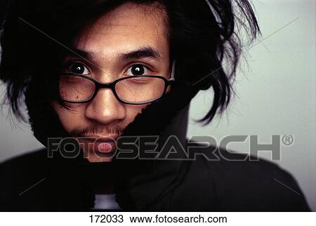 Stock Image - Young man with black sweater and messy hair. Fotosearch