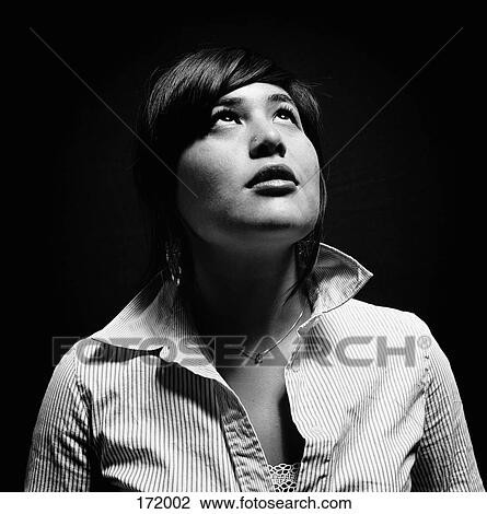 Young woman looking up View Large Photo Image Stock Image - Young woman looking up. Fotosearch